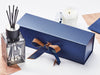 A diffuser with a blue gift box and candle on a white background