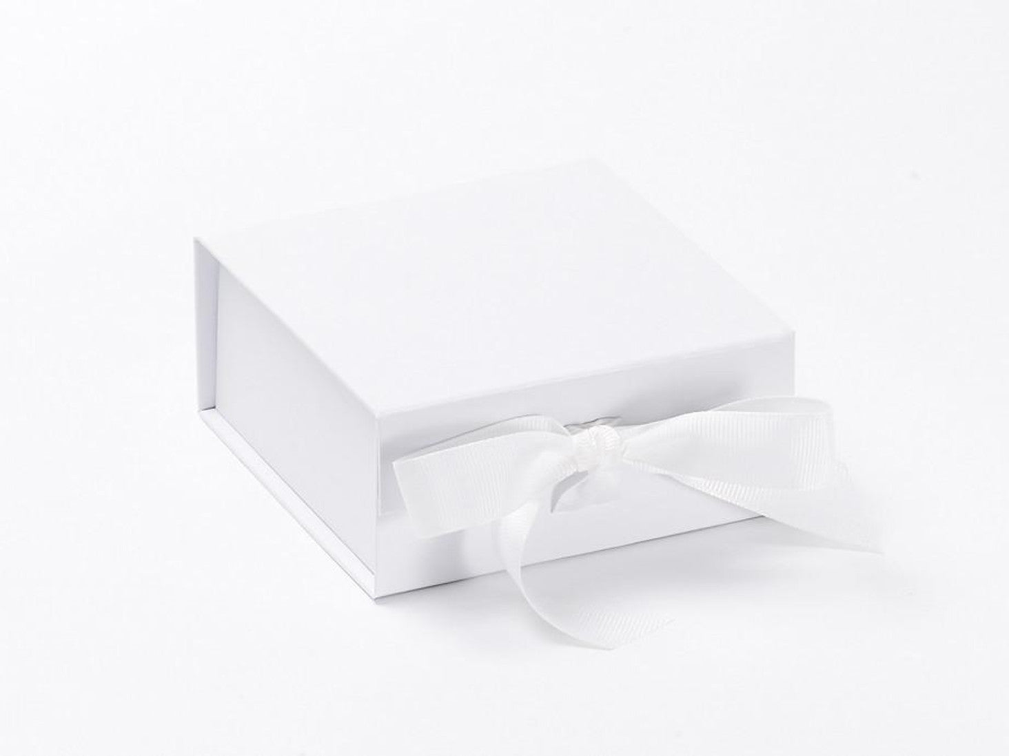 Small white folding magnetic gift box with fixed ribbon ties
