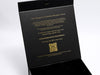 Black box with gold foiled text and QR code on a white background