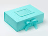 Turquoise gift box with a bow on a white background