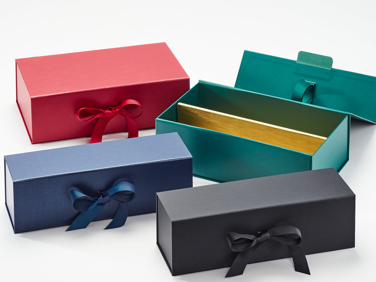 Four gift boxes in red, blue, green, and black with ribbons on a white background