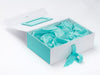 Gift box with turquoise interior and ribbon on a white background