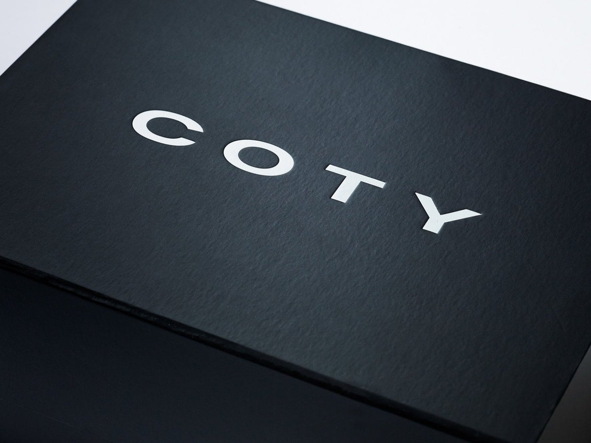 Black Folding Gift Box with Custom Printed White Coty Logo to Lid