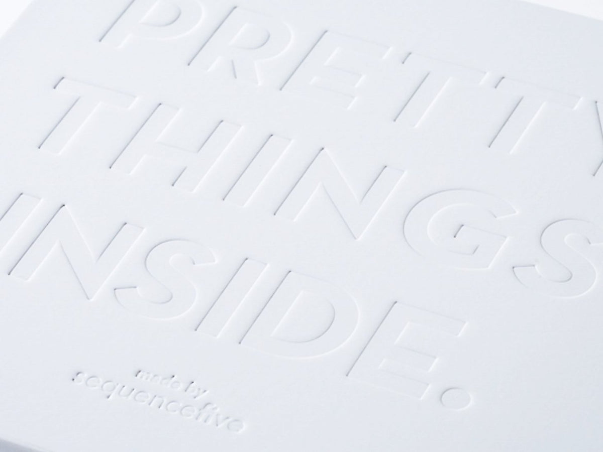 Deep Debossed Logo to Lid of White Gift Box